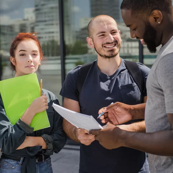 Smiling-students-with-papers.jpg